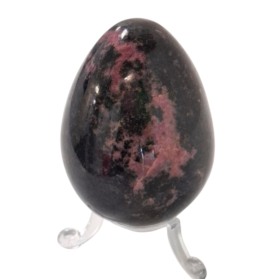 Polished Rhodonite crystal egg with included stand, symbol of emotional healing and heart chakra balance