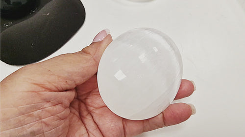 13-second video showing three Selenite Palm Stones in 50 mm, 70 mm, and 90 mm sizes. Each stone is displayed individually in hand, with a group shot of all three sizes resting together on the palm to show scale.
