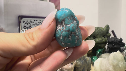 GeoFossils Kingman Mine Turquoise drilled tumblestone shown from multiple angles, highlighting its polished blue surface, natural dark grey and pale matrix patterns, irregular shape and drilled hole.