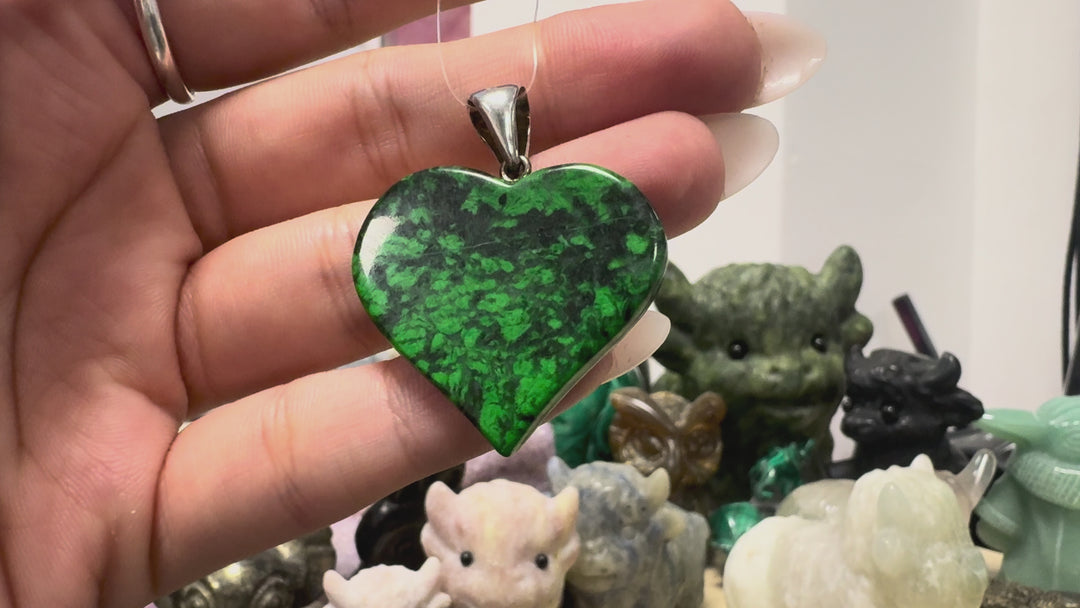 GeoFossils video showcasing the one-of-a-kind Maw Sit Sit heart pendant from Burma (Myanmar), highlighting its vibrant green and black natural patterning, polished finish and sterling silver fitting. The pendant measures approximately 4 cm in total height, including the bail.