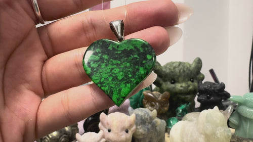 GeoFossils video showcasing the one-of-a-kind Maw Sit Sit heart pendant from Burma (Myanmar), highlighting its vibrant green and black natural patterning, polished finish and sterling silver fitting. The pendant measures approximately 4 cm in total height, including the bail.