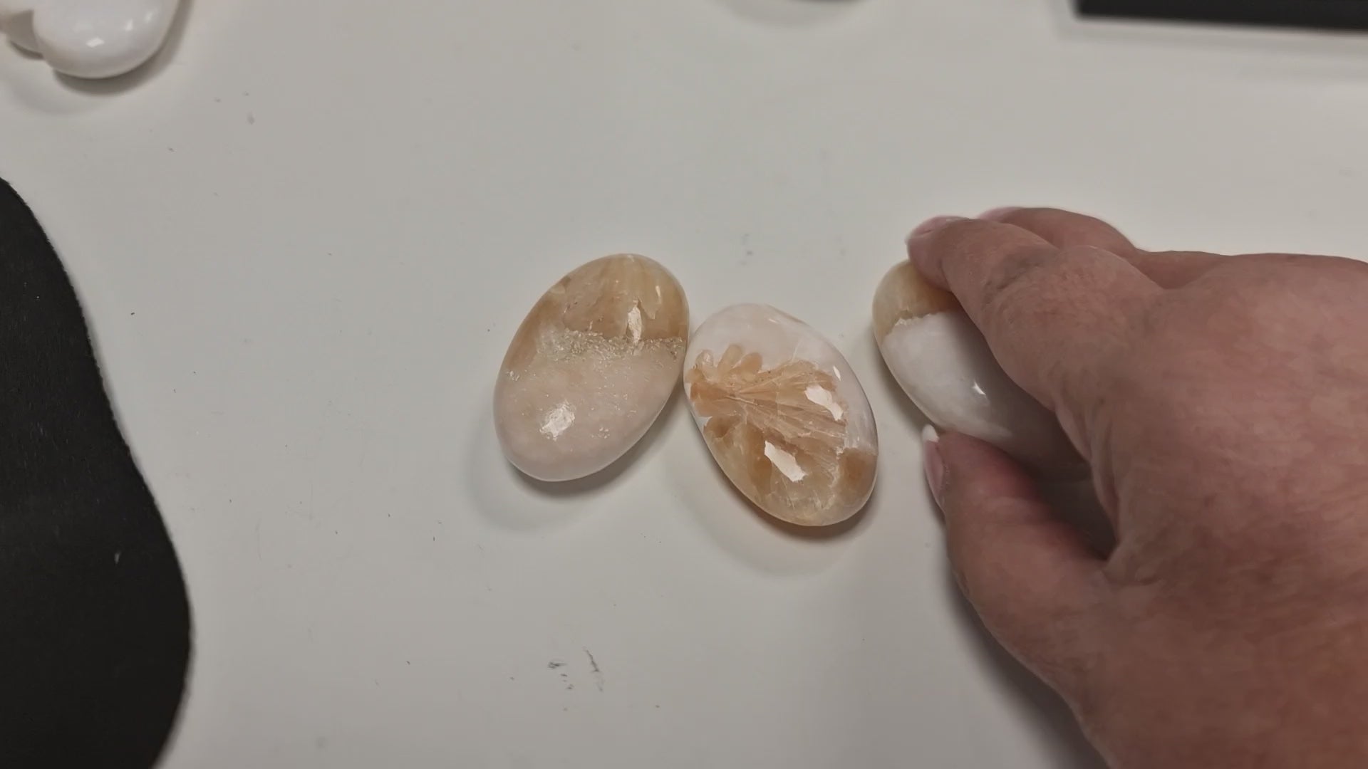A slow turn of the small Scolecite & Stilbite palm stone, showing delicate crystal patterns and soft shimmer under gentle lighting.