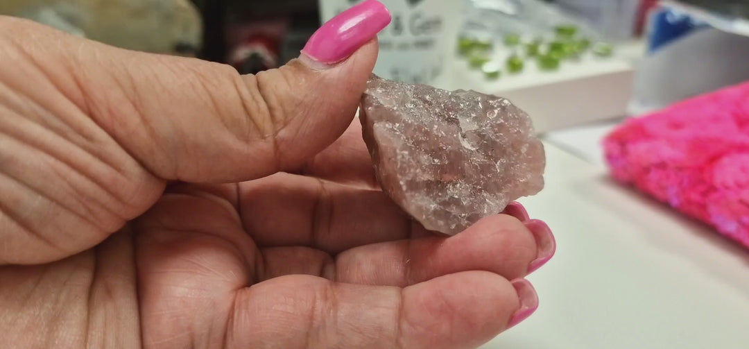 A slow rotating video of a natural Guava Quartz raw mineral specimen, showcasing its soft pink, peach, and coral colouring, natural crystal textures, and unique geological features from every angle.