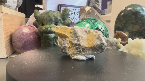 Rotating view of a Coloradoite mineral specimen from Bassie G Mine, La Plata County, Colorado, USA, part of the Dr T.K. Devon Collection. Showcasing golden-yellow mineralisation, contrasting grey and white matrix, and naturally textured surfaces from multiple angles.