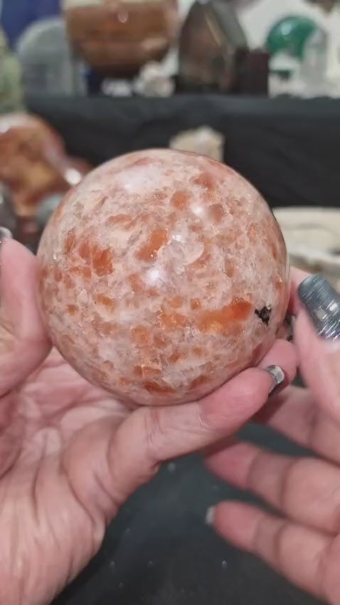 GeoFossils Polished Sunstone sphere with vibrant orange flash and shimmering inclusions, offered as a one-off in a live crystal auction.
