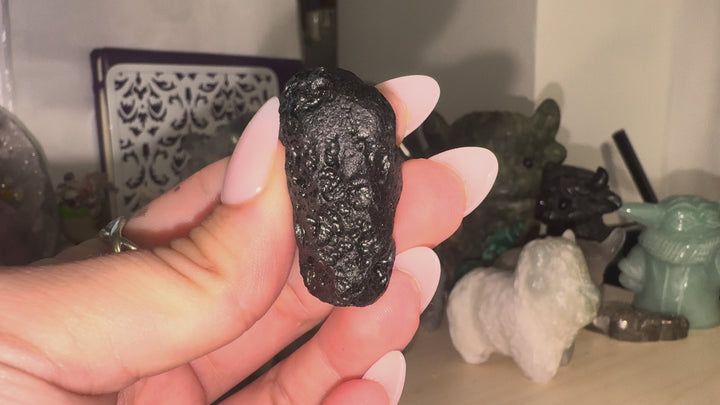 GeoFossils video showcasing a selection of Tibetan Tektite specimens, highlighting their irregular shapes, dark glassy surfaces, natural grooves, pits and distinctive textures from different angles.