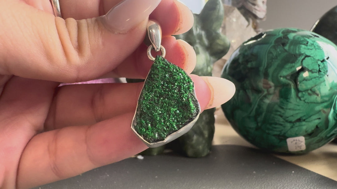 GeoFossils natural Uvarovite Garnet pendant product video showcasing the sparkling emerald-green druzy crystals, dark mineral matrix, silver setting and 925 sterling silver bail.