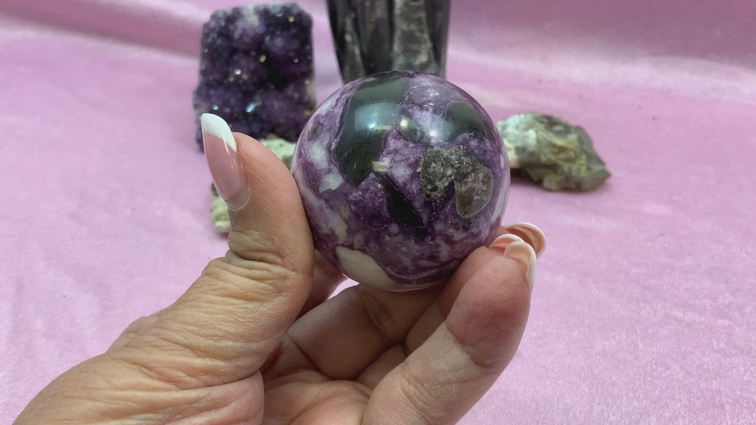 A rotating video of the Iowaite sphere, capturing its gentle shimmer and green tones as it turns in soft lighting, highlighting its polished surface and rare beauty.