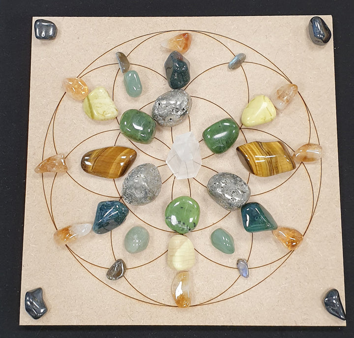 Abundance crystal grid set on a Seed of Life MDF board, featuring Citrine, Clear Quartz, and other manifestation stones arranged in sacred geometry.