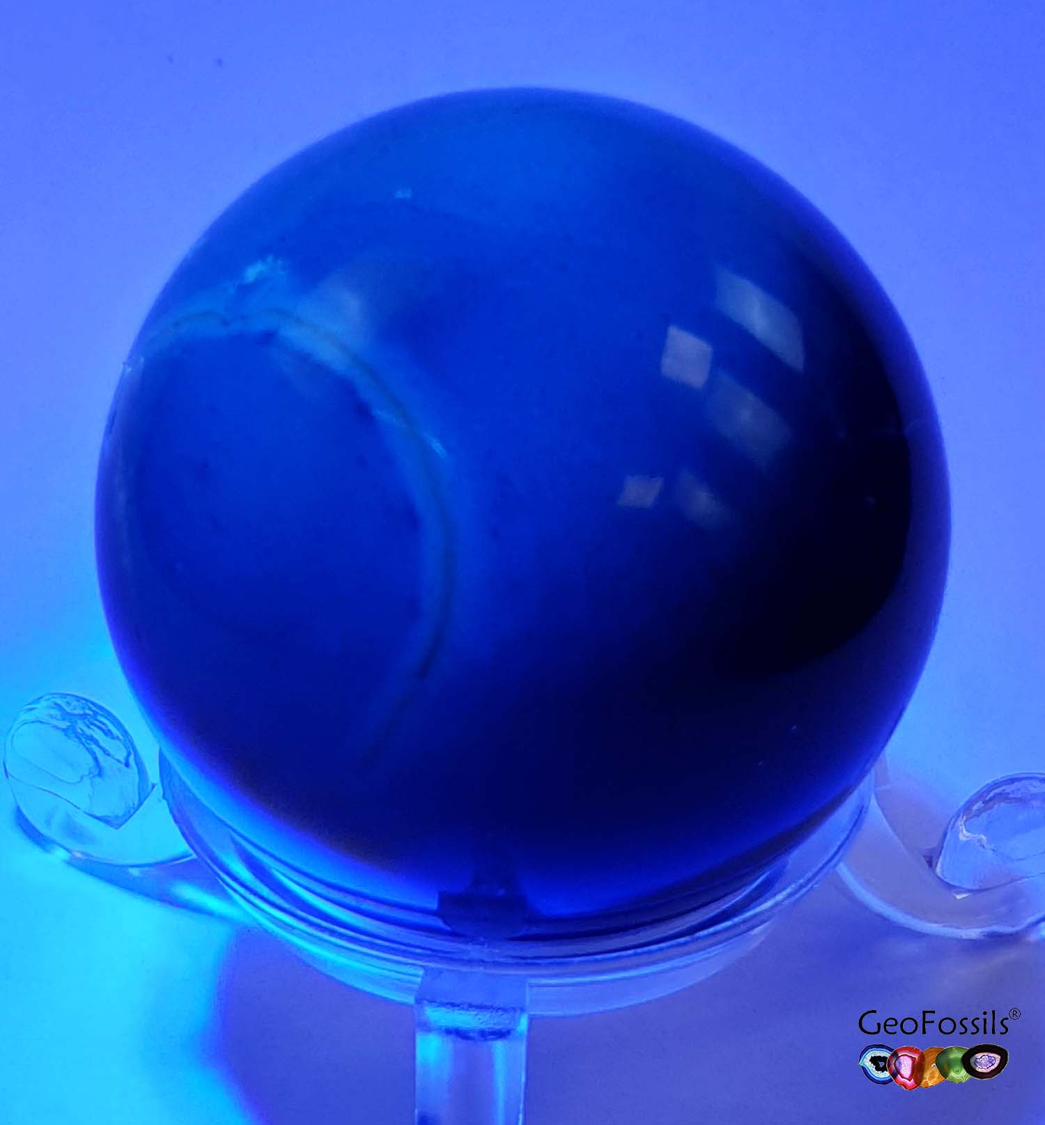 GeoFossils Blue Amber Sphere from the Dominican Republic, a rare fossilised resin with a stunning blue fluorescence for intuition, transformation, and protection.