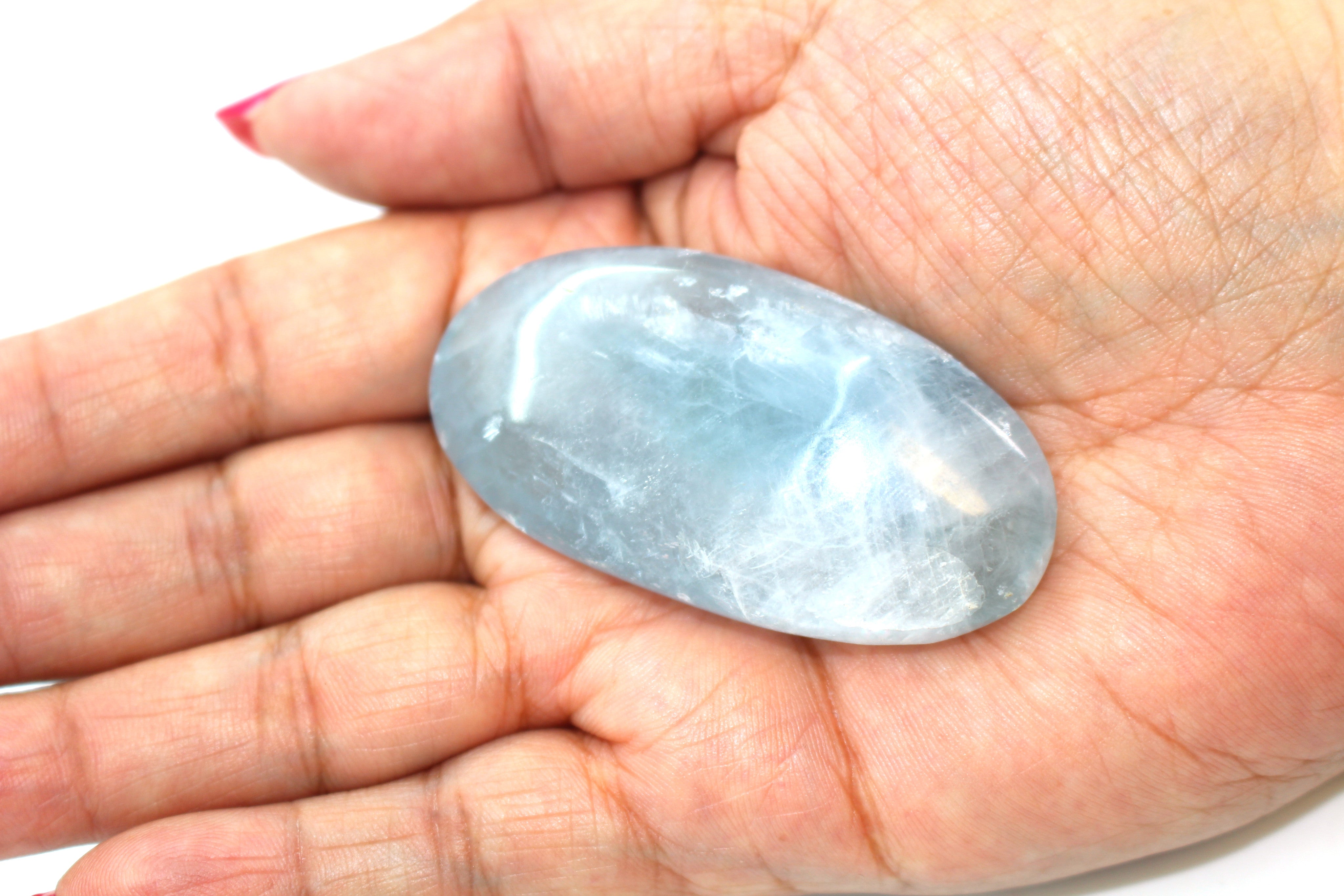 GeoFossils Celestite Palm Stone, a soft sky-blue crystal for peace, clarity, and divine connection.