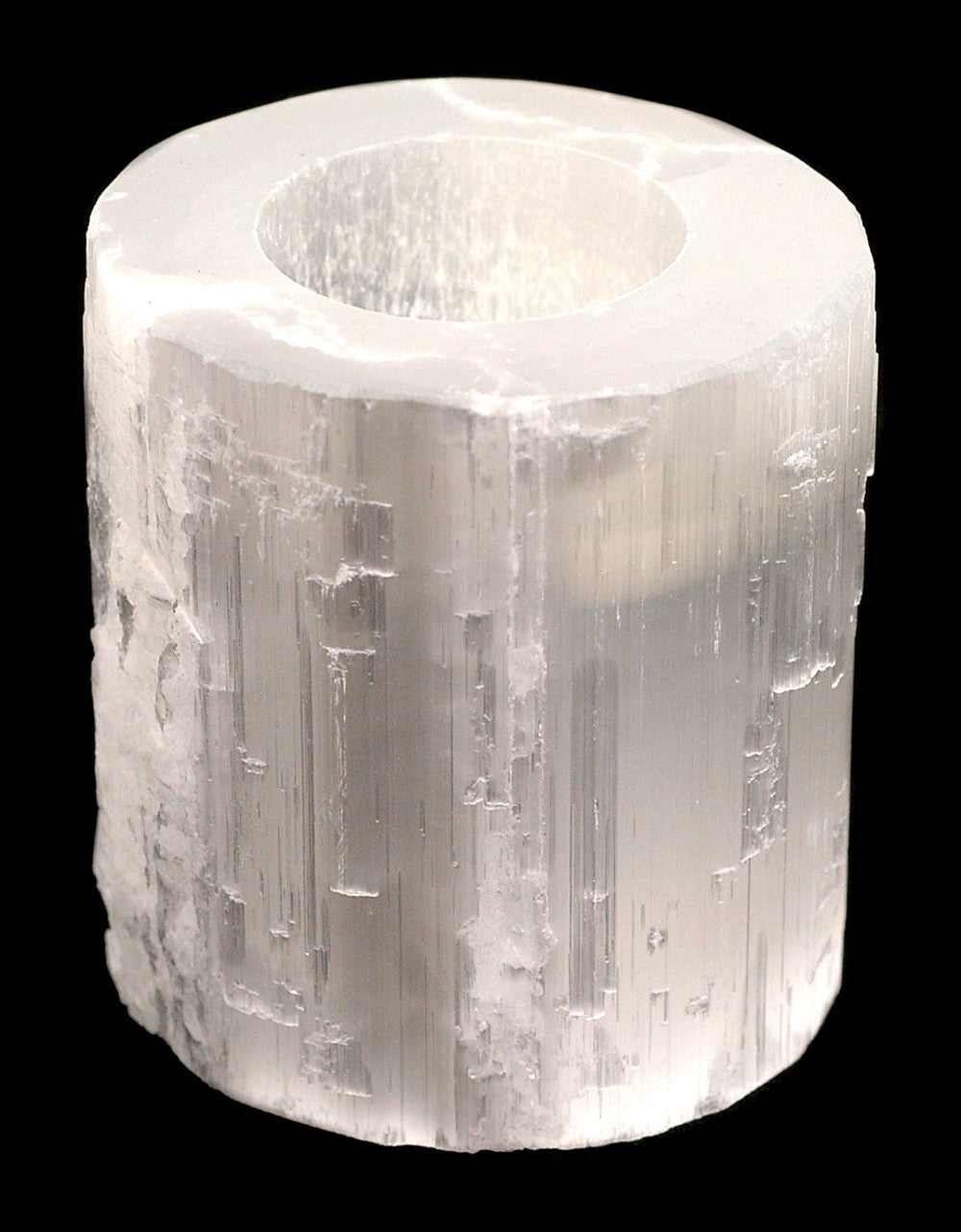 Top Polished Selenite Tealight Holder with raw natural sides and a smooth polished top, glowing softly when lit.