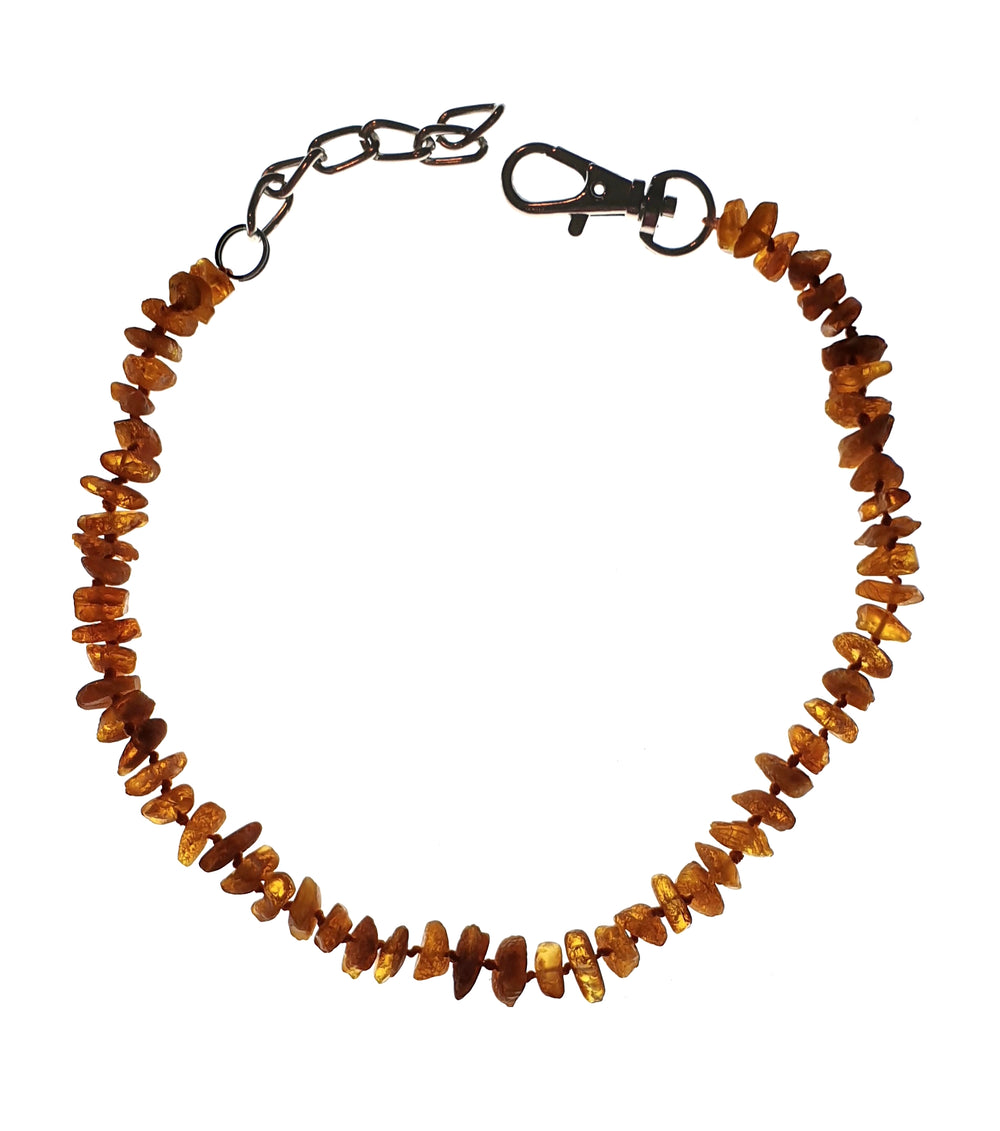 Orange smooth chips on a wire as a collar with clip